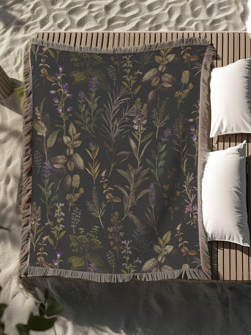 Forest green cotton throw blanket with woven silver moon phases and golden sun motifs, finished with multicolored fringe trim.