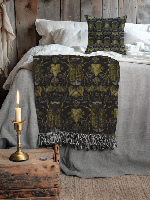 Luxurious woven cotton throw blanket featuring symmetrical scarab beetle pattern in olive green on black background with white fringe trim. Perfect for dark academia, gothic, or cottagecore decor as wall hanging or cozy throw. Mystical home gift.