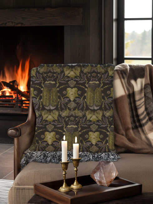 Luxurious woven cotton throw blanket featuring symmetrical scarab beetle pattern in olive green on black background with white fringe trim. Perfect for dark academia, gothic, or cottagecore decor as wall hanging or cozy throw. Mystical home gift.