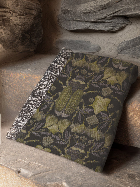 Luxurious woven cotton throw blanket featuring symmetrical scarab beetle pattern in olive green on black background with white fringe trim. Perfect for dark academia, gothic, or cottagecore decor as wall hanging or cozy throw. Mystical home gift.