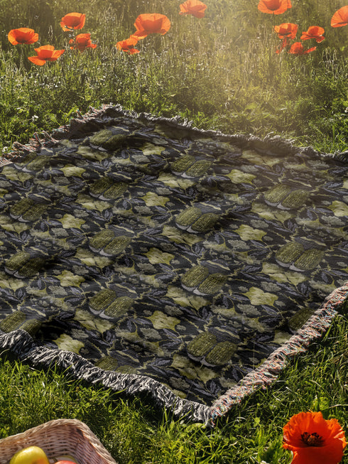 Luxurious woven cotton throw blanket featuring symmetrical scarab beetle pattern in olive green on black background with white fringe trim. Perfect for dark academia, gothic, or cottagecore decor as wall hanging or cozy throw. Mystical home gift.