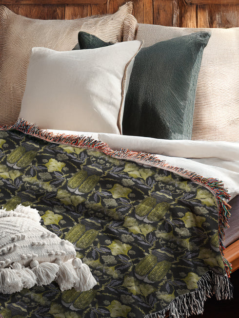 Luxurious woven cotton throw blanket featuring symmetrical scarab beetle pattern in olive green on black background with white fringe trim. Perfect for dark academia, gothic, or cottagecore decor as wall hanging or cozy throw. Mystical home gift.