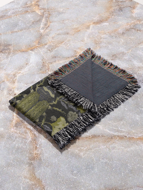 Luxurious woven cotton throw blanket featuring symmetrical scarab beetle pattern in olive green on black background with white fringe trim. Perfect for dark academia, gothic, or cottagecore decor as wall hanging or cozy throw. Mystical home gift.