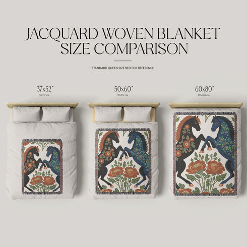 A woven cotton throw blanket by Grimoire and Goblet featuring two rearing horses facing each other in a symmetrical folk art design. One horse is charcoal black with rust floral detailing; the other is navy blue with teal floral detailing. They are framed by large rust-colored peonies and green leafy vines on a cream background. The blanket features a multicolor fringe edge. Perfect for dark academia and cottagecore aesthetics.