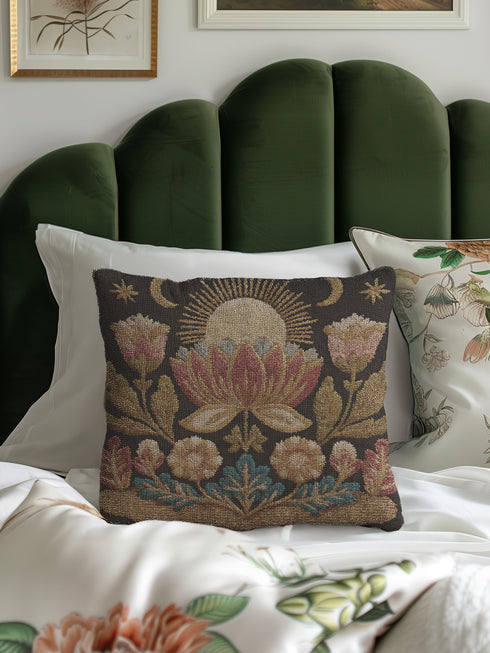 Woven tapestry pillow, 17" x 18", showcasing a radiant sun above a lotus with crescent moons and florals in gold, berry, and teal on black. Artisan-woven 58% cotton, 42% polyester; stuffed with soft polyfill. Sewn-shut construction; pattern duplicated on both sides. Luxe, symbolic woven pillow for celestial décor, dark-academia styling, and enchanting living spaces.