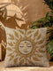 A square woven tapestry throw pillow in neutral earth tones of beige and gold. The pillow has a rich, textured surface from its jacquard weave. The design features a large, central celestial sun face with closed eyes, a serene smile, and a third eye symbol on its forehead. The sun's rays are stylized as intricate leaves, blending botanical and solar motifs. The pillow is made from a durable cotton and polyester blend, giving it a high-quality, artisanal feel.