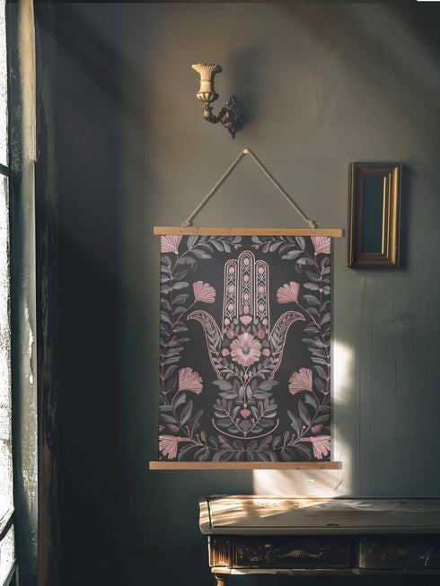Botanical Hamsa wall tapestry featuring intricate rose gold and teal design on black background, showing a protective hand symbol surrounded by leaf motifs and floral elements, hanging from wooden dowels with natural twine.