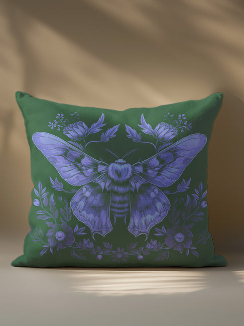 A decorative pillow cover featuring an intricate Luna moth illustration in lavender purple on an emerald green background, adorned with symmetrical botanical details and florals in a vintage naturalist style.