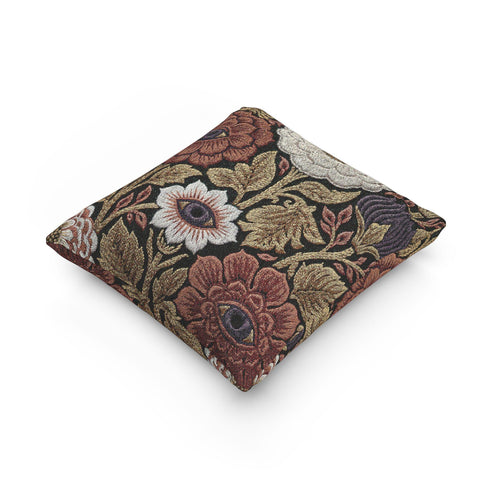 A square woven throw pillow featuring a surreal botanical design on a solid black background. The tapestry-style fabric showcases large, detailed flowers in shades of rust red, cream, and olive green. Nestled within the center of each prominent blossom is a detailed, human-like eye with a dark plum iris, creating a striking evil eye motif. The interwoven threads give the pillow a rich, textured appearance. The pillow is fully stuffed and sewn closed, presenting a smooth, seamless edge.