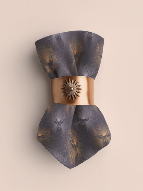 Set of four slate blue dining napkins featuring alternating gold and silver ravens in flight with botanical accents, sized 18x18 inches.