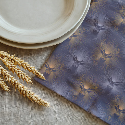 a table with a plate, napkin, and wheat stalks on it