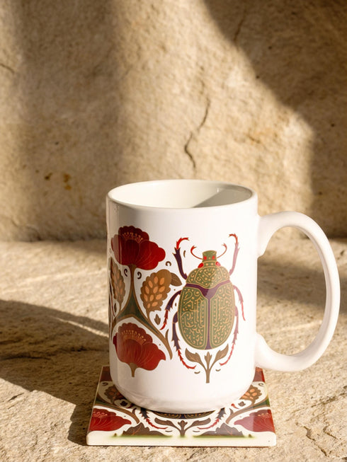 A luxury gift set featuring a matching ceramic mug and square coaster with a vintage entomology design. The artwork depicts a vibrant green Scarab beetle with iridescent wings, surrounded by dark moody floral botanicals in rust and ochre, set against a creamy background in a Victorian naturalist style. The mug is 15oz with a large handle and full wrap design. The coaster is glazed ceramic tile with a cork backing. Perfect for Dark Academia and Grimoire and Goblet gothic home decor.