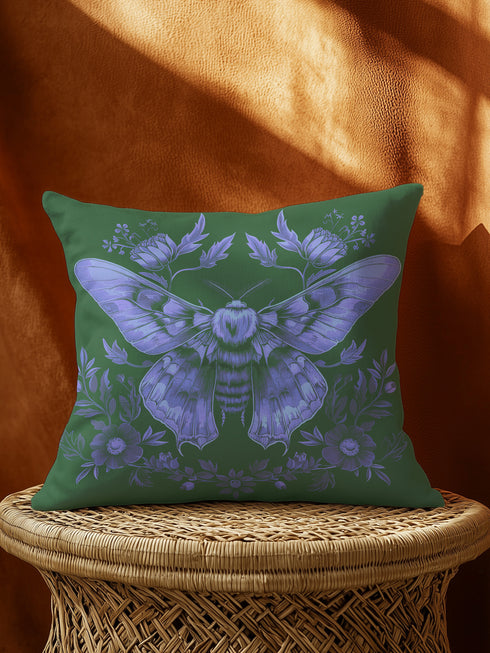 A decorative pillow cover featuring an intricate Luna moth illustration in lavender purple on an emerald green background, adorned with symmetrical botanical details and florals in a vintage naturalist style.