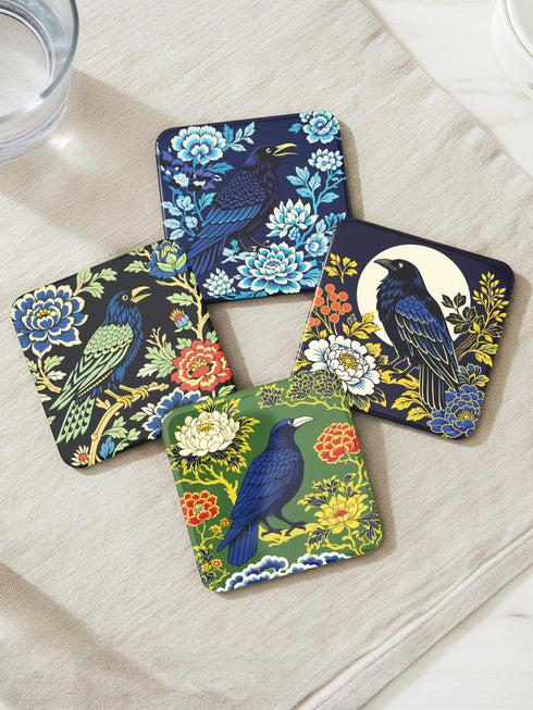 Grimoire and Goblet set of 4 glossy square coasters featuring Chinoiserie style raven illustrations. 1: Navy blue with blue floral pattern and raven. 2: Navy background with black raven, white full moon, and red berries. 3: Moss green background with blue bird and yellow chrysanthemums. 4: Black background with teal-winged raven and red peonies. MDF hardboard with cork backing. Flat vector botanical art style.