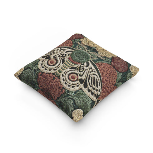 Square 17 by 18 inch jacquard woven throw pillow, woven identically on both faces and closed with a clean sewn edge. A symmetrical emperor moth with wings detailed in black, warm gold, and deep burgundy red spreads across the center of a dark forest green ground. A large golden yellow flower blooms above the moth and burgundy floral buds sit on either side among woven botanical sprays. The design is woven flat into the cotton blend cloth with visible thread texture.