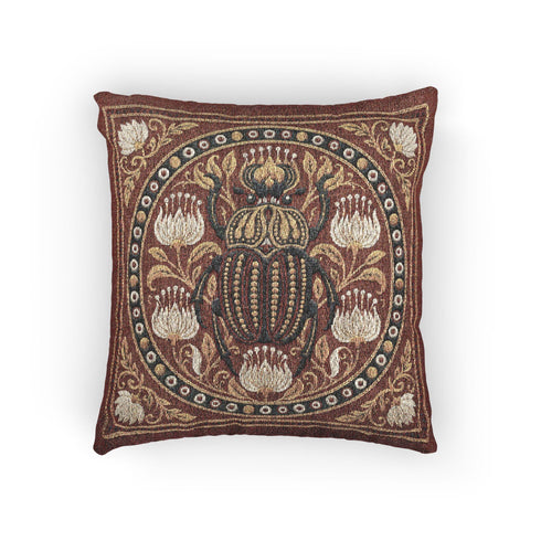 Square 17 by 18 inch jacquard woven throw pillow, woven identically on both faces and closed with a clean finished edge. A large detailed scarab beetle in black, gold, and dark brown sits at the center inside a dotted circular border, surrounded by symmetrical Art Nouveau vines and cream lotus flowers on a rust red ground. Small white floral motifs sit in each corner. The design is woven flat into the cotton blend cloth, with visible thread texture and a soft sheen in the ground.