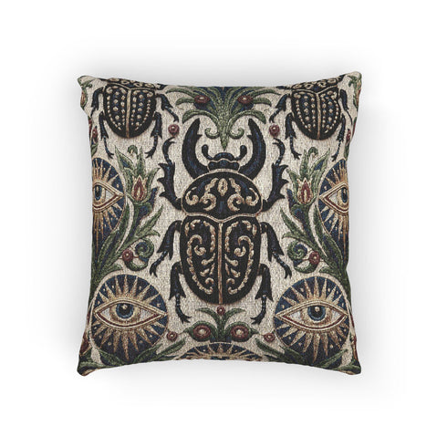 Square 17 by 18 inch jacquard woven throw pillow, woven identically on both faces and closed with a clean finished edge. On a natural cream ecru ground, a horned scarab beetle with gold filigree scrollwork on its shell sits at the center, flanked by two evil eye medallions with sapphire blue centers in sunburst halos. Two smaller scarabs, sage green acanthus vines, and crimson berries frame the edges. The design is woven flat into the cotton blend cloth with visible thread texture.