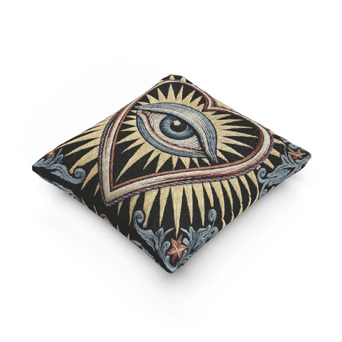 Square 17 by 18 inch jacquard woven throw pillow, woven identically on both faces and closed with a clean finished edge. On a solid black ground, a large blue evil eye sits inside a golden sunburst heart. Gold, pale blue, cream, and rust threads form the design, with dusty blue acanthus leaves curling around the heart and small rust stars in each corner. The design is woven flat into the cotton blend cloth, with visible thread texture and a heavy tapestry hand.